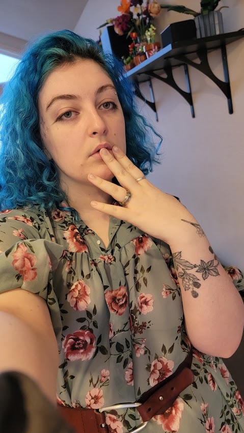 someone wearing a flowy floral print dress