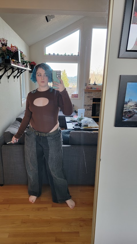someone wearing a brown bodysuit with a large oval cutout in the center of the chest.